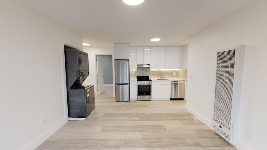 A kitchen area with a refrigerator, oven, and microwave.